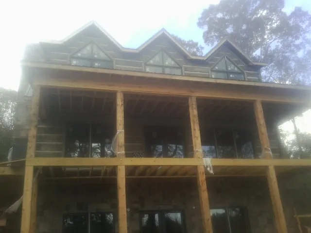 Dormers and porch framing on a large log home under construction in Harrellsville