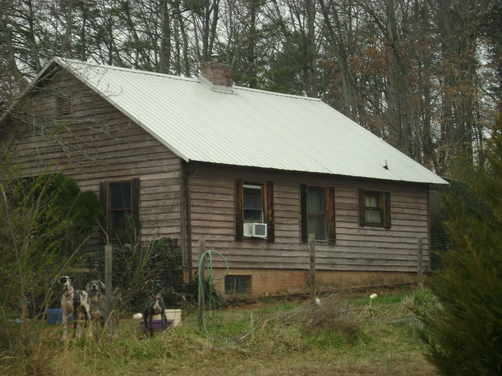White metal roof on an old wood sided farmhouse, from a Asphalt Shingle Roof Repair job in Harrellsville